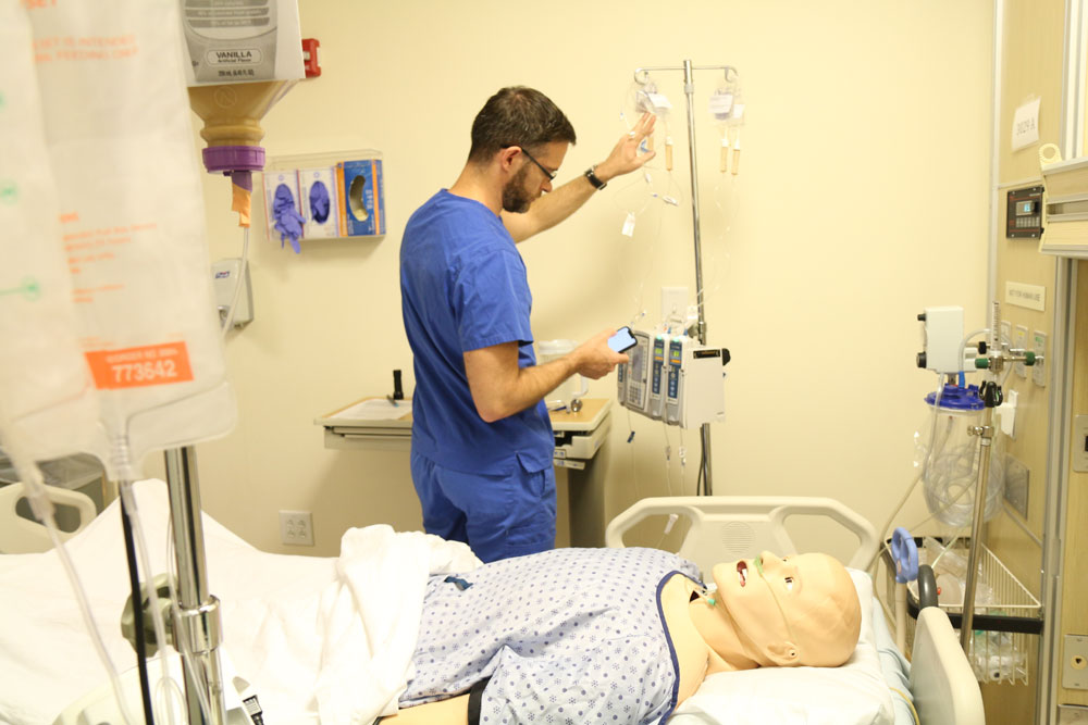 An advanced practice nurse checks a patient's readings.