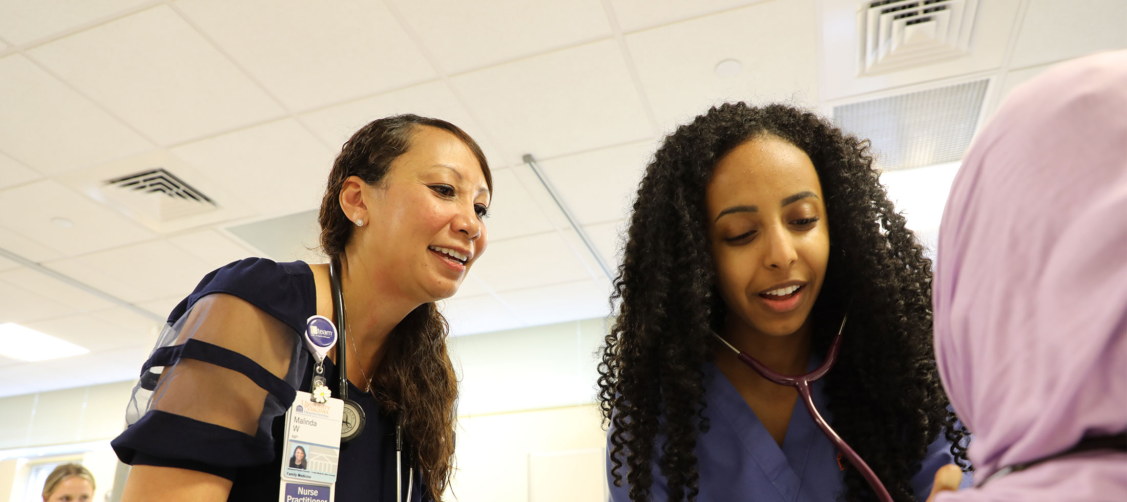 BSN student listening to patient with stethoscope