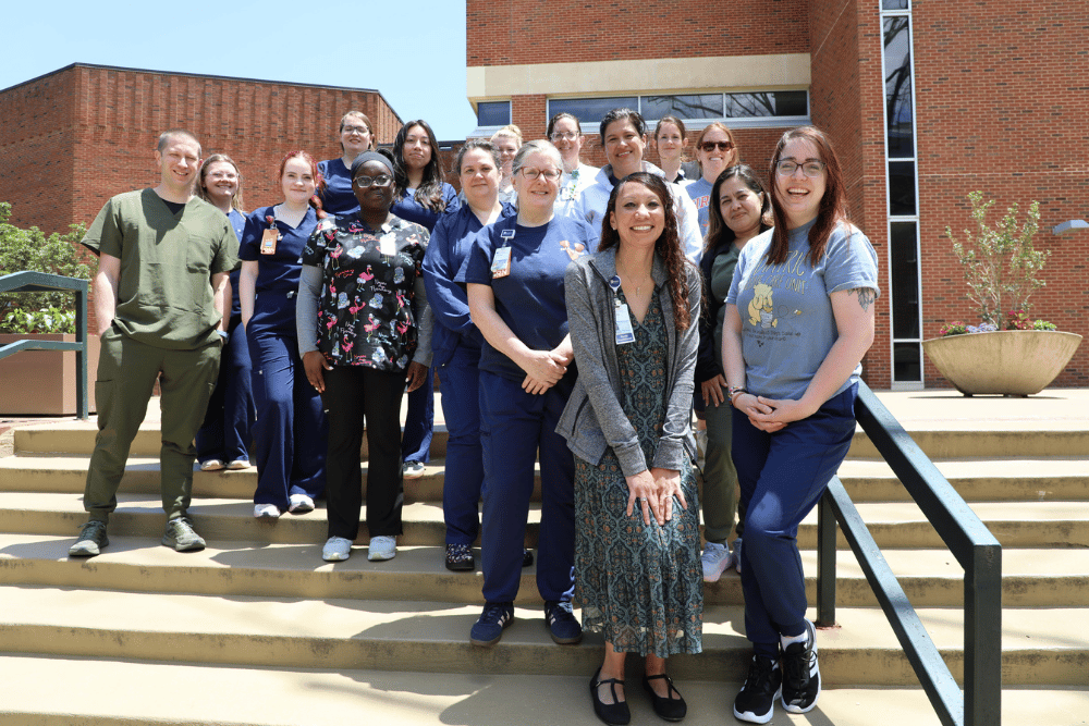 a group of RN to BSN students standing on steps outside McLeod Hall