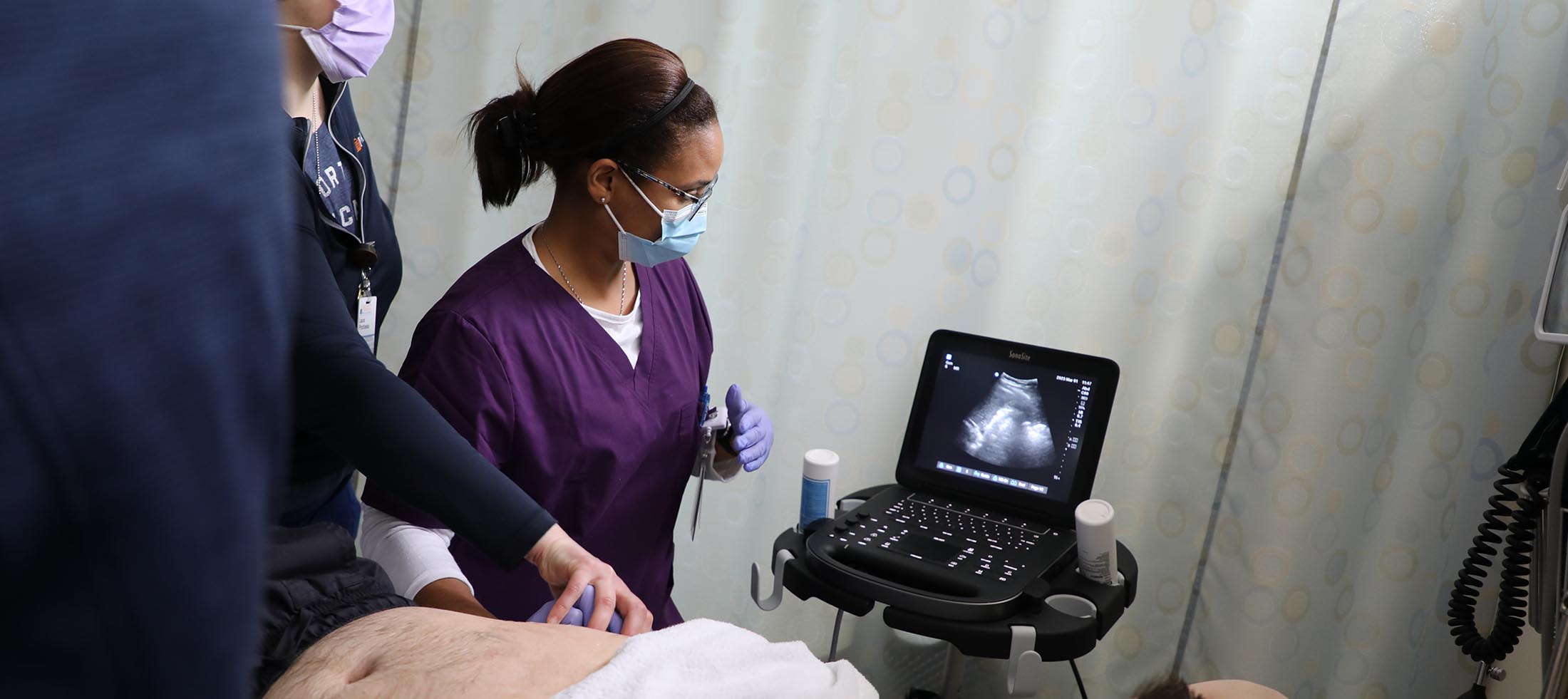 A nursing student doing a sonogram