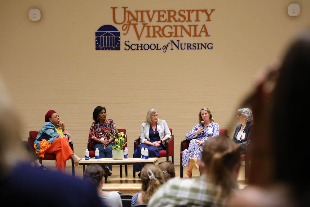 A panel of speakers on stage