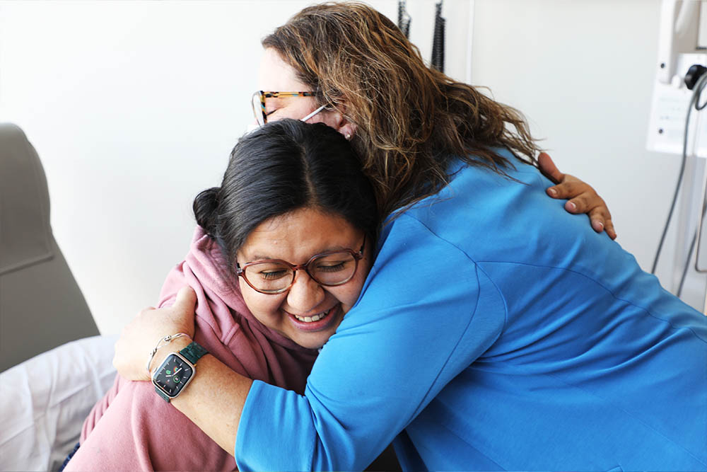 Preceptor and NP Christy Murray hugs Candice Hines, mom to a pediatric cancer pt