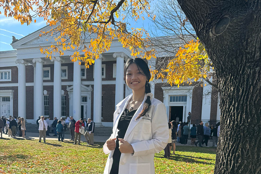 A nursing student in a white coat