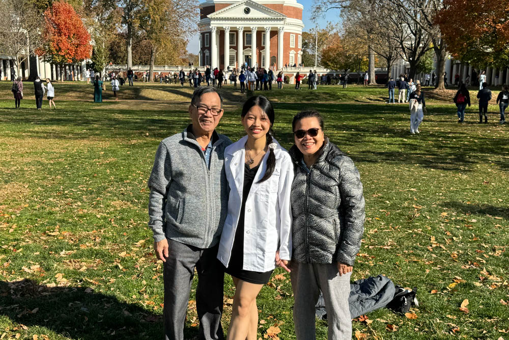 three people standing on UVA Lawn