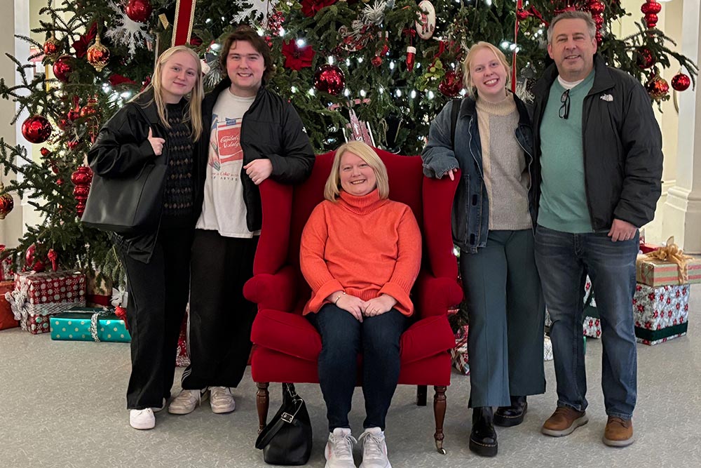 A family in front of a. tree