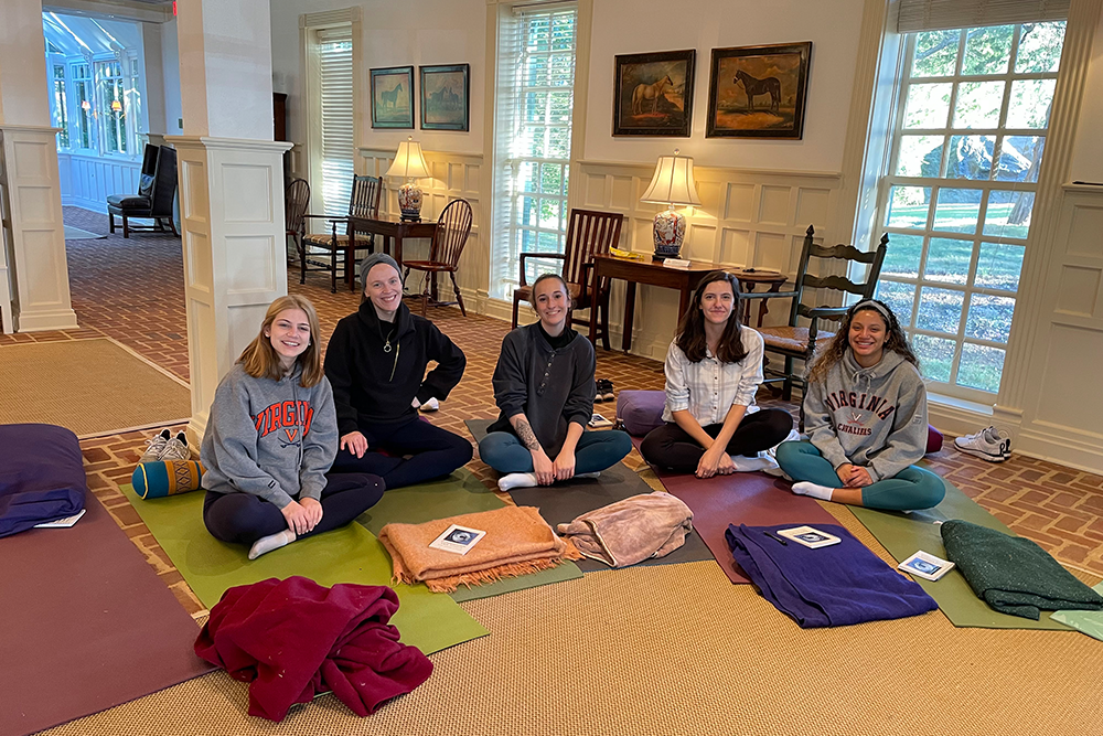 Photo of ABSN student McKenna Mason enjoying yoga with her fellow nursing students.