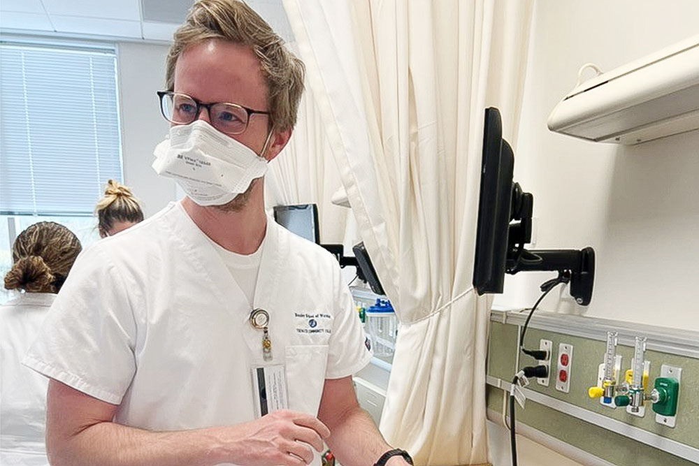 A nurse in a sim lab wearing a mask