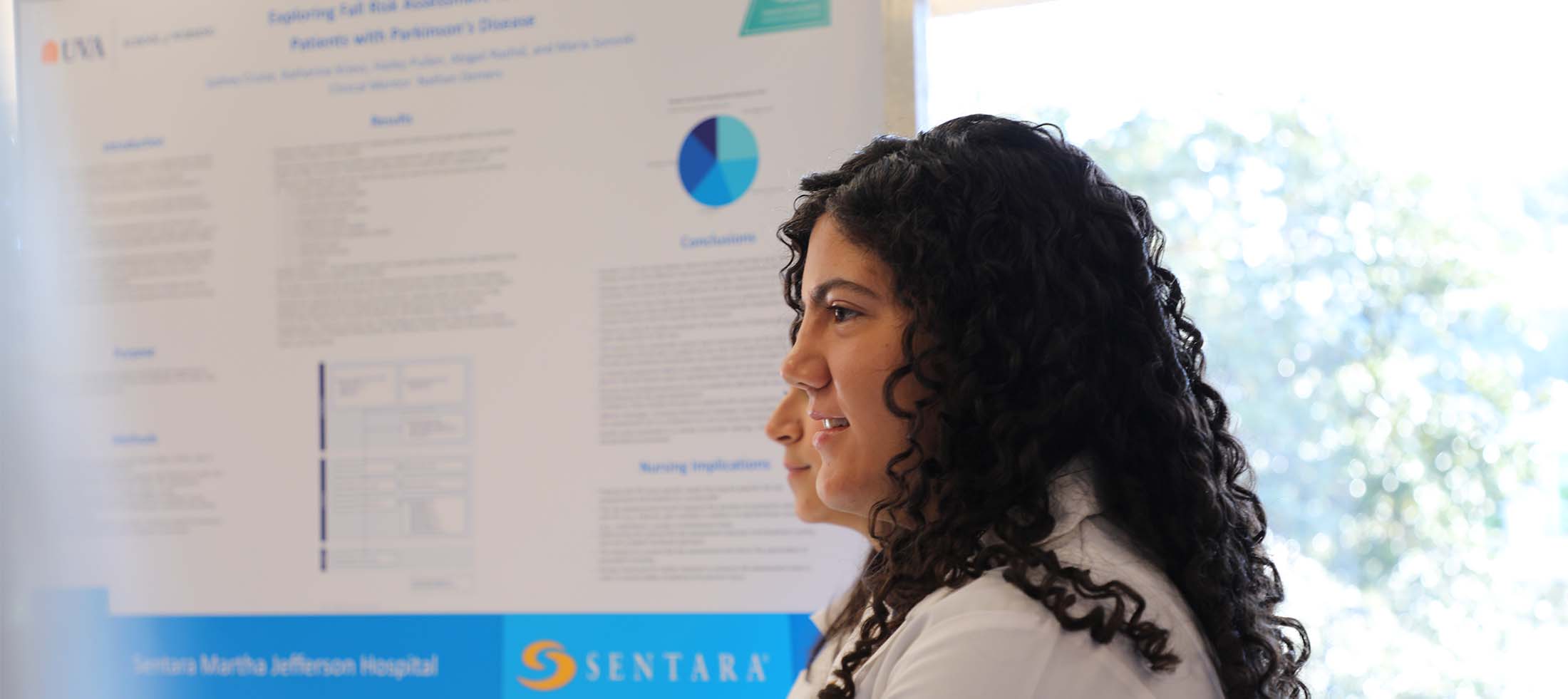 A young woman presenting a poster