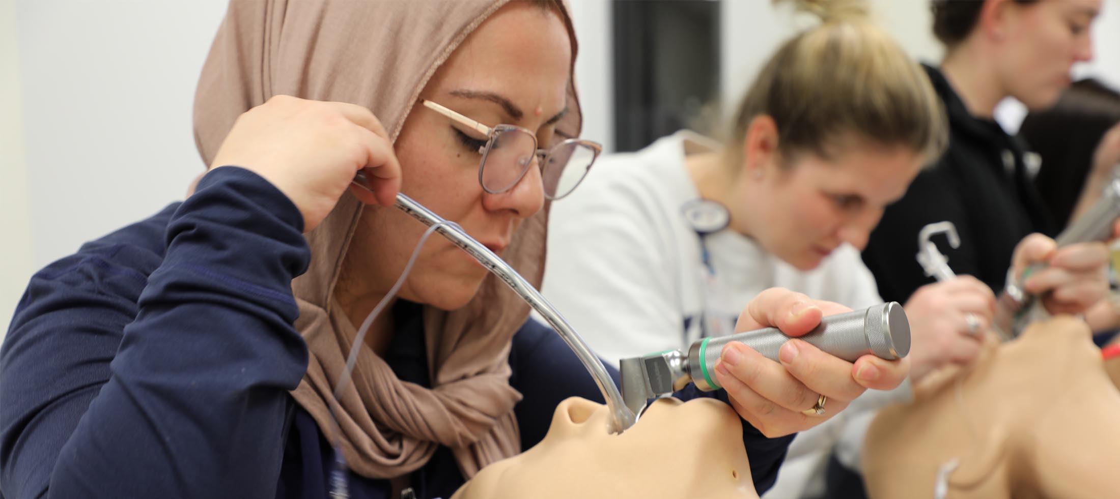 A nursing student practicing in a lab