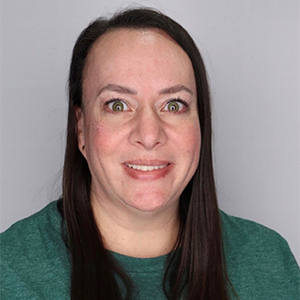 image of a woman with brown hair and green long-sleeve