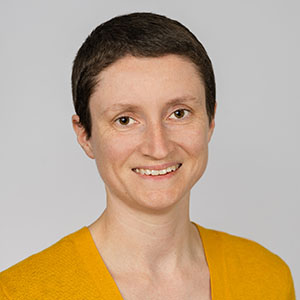 A smiling woman yellow sweater