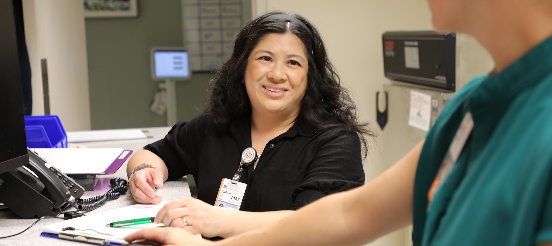 Nurse practitioner May Gallanosa talking to a peer